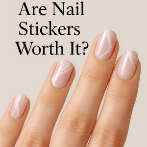 A close-up of a beautiful hand, showcasing pastel pink nail stickers with subtle gold glitter, invites you to reflect: Are nail stickers truly enough to achieve elegance?
