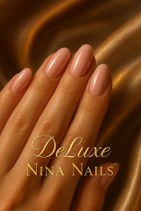 Luxury polished nails with pastel pink manicure on a woman's hand resting on golden satin fabric, featuring the text DeLuxe Nina Nails in elegant gold lettering